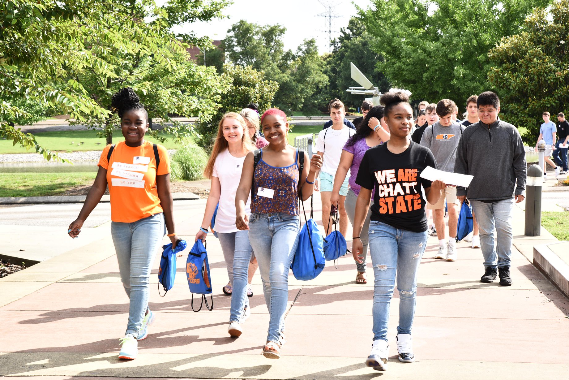  Students walking on sidewalk surrounded by trees at ChattState.